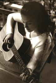 Wendy Curl playing an acoustic guitar